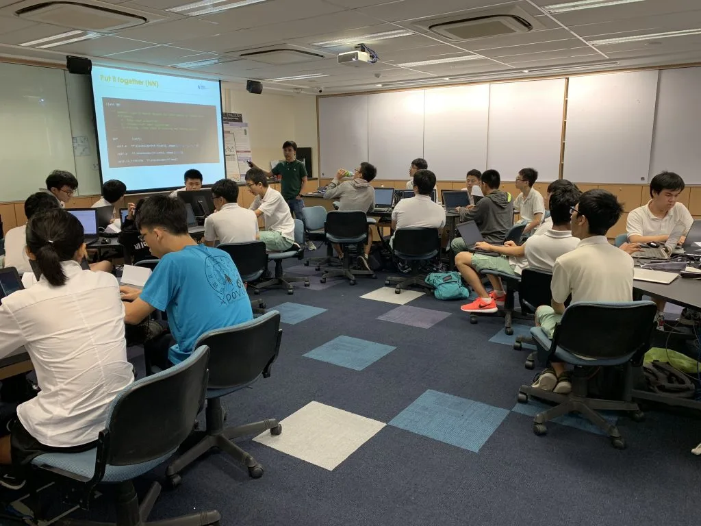 Tuan covering the neural network implementation of an image classifier using TensorFlow, with the students following a set of hands-on exercises