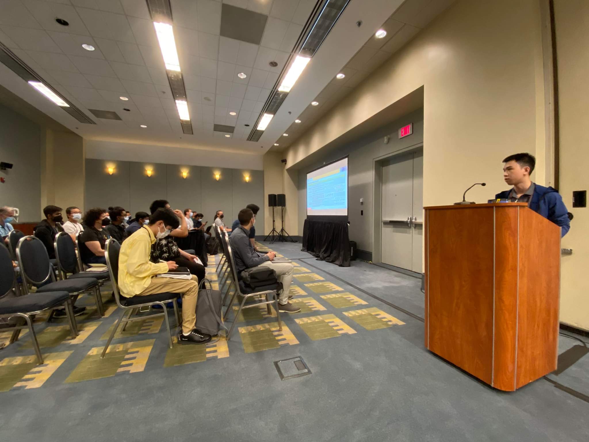 Thuat giving a 15-minute oral presentation for his paper